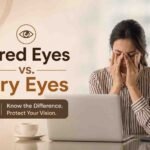Woman rubbing her eyes while working on a laptop, illustrating the difference between tired eyes and dry eyes caused by prolonged screen use.