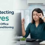 Woman rubbing her eye while working in an air-conditioned office.