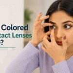 Woman inserting a colored contact lens into her eye.